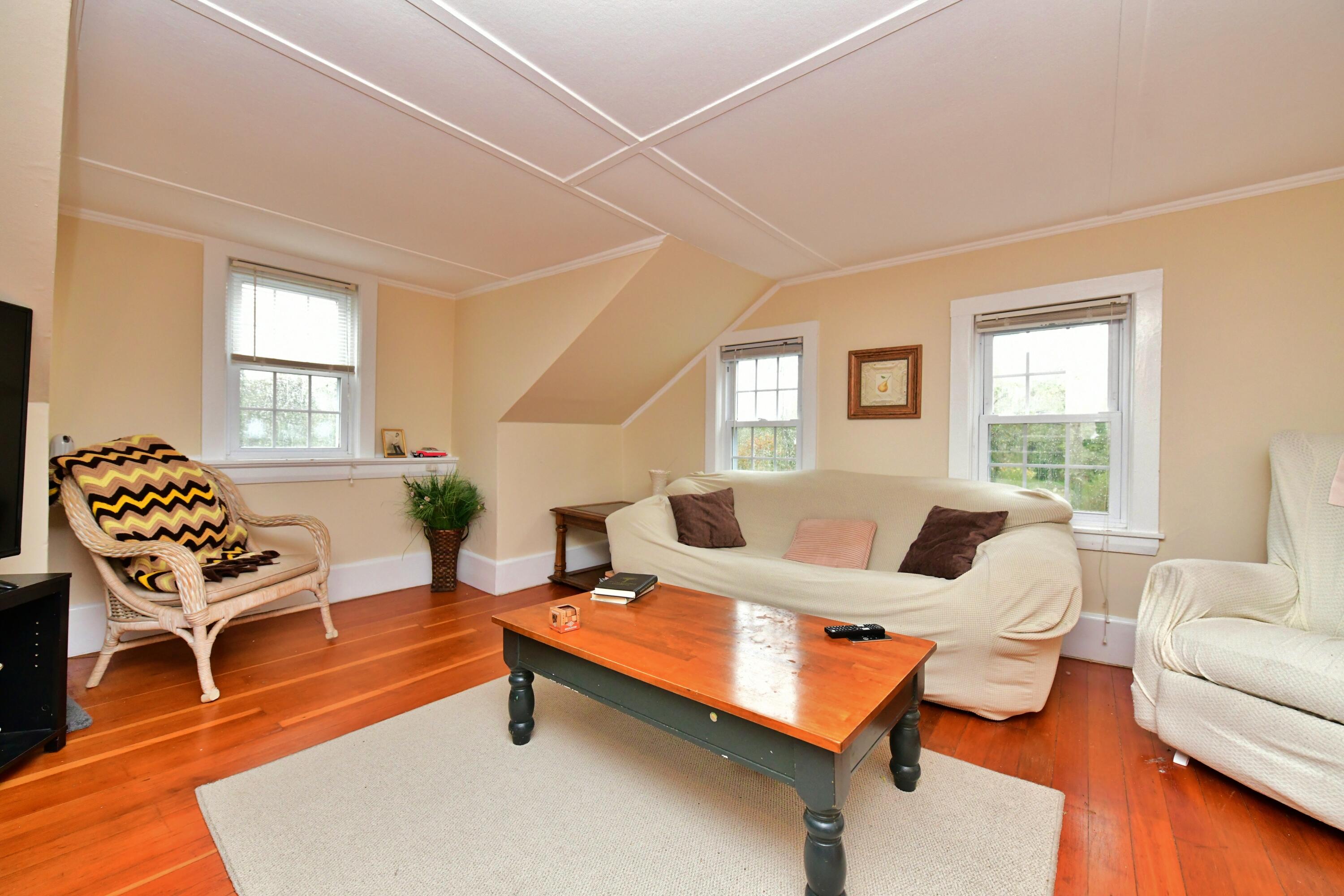 6 Bournedale Road, Unit 6B 2 Buzzards Bay, MA 02532 - Photo 9 of 36 a living room with furniture and wooden floor