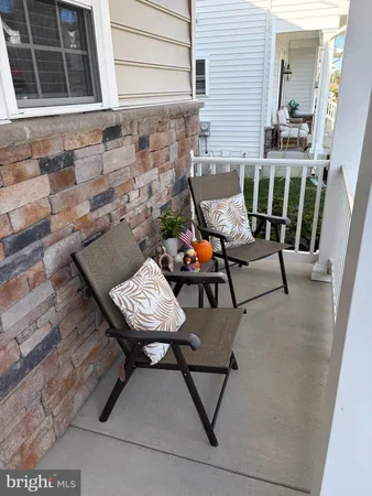a balcony with table and chairs