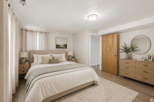 270 East 700 North Logan, UT 84321 - Photo 26 of 42 Virtually Staged Bedroom featuring wood-finish flooring and a light-toned area rug