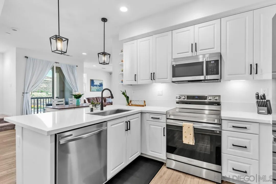 2811 Safflower Street Spring Valley, CA 91977 - Photo 5 of 28 a kitchen with cabinets stainless steel appliances and a sink
