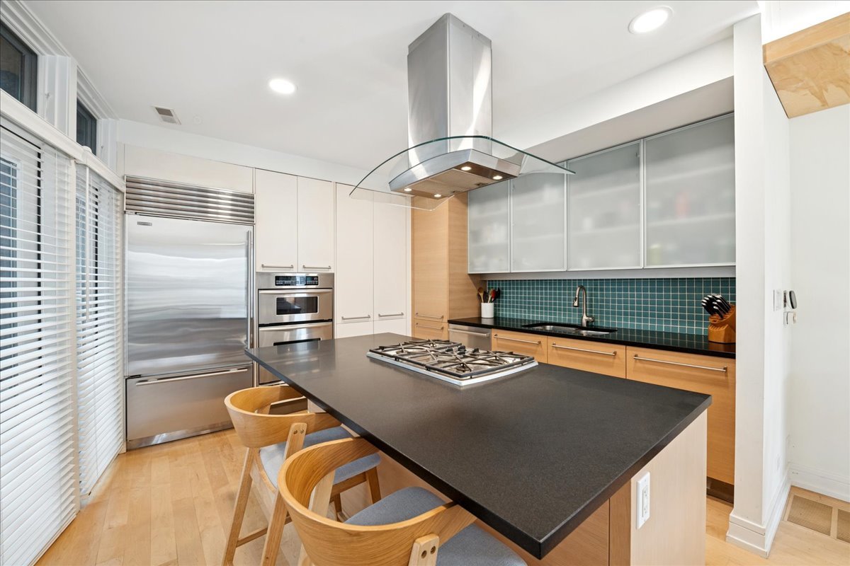 1915 North Damen Avenue, Unit A Chicago, IL 60647 - Photo 11 of 26 a kitchen with stainless steel appliances granite countertop a sink a stove and a refrigerator