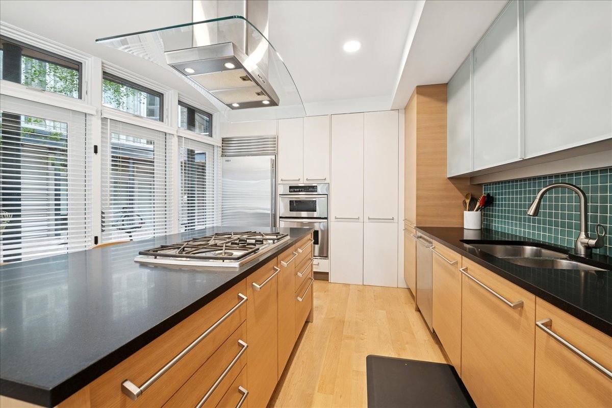 1915 North Damen Avenue, Unit A Chicago, IL 60647 - Photo 12 of 26 a kitchen with stainless steel appliances granite countertop a stove and a sink