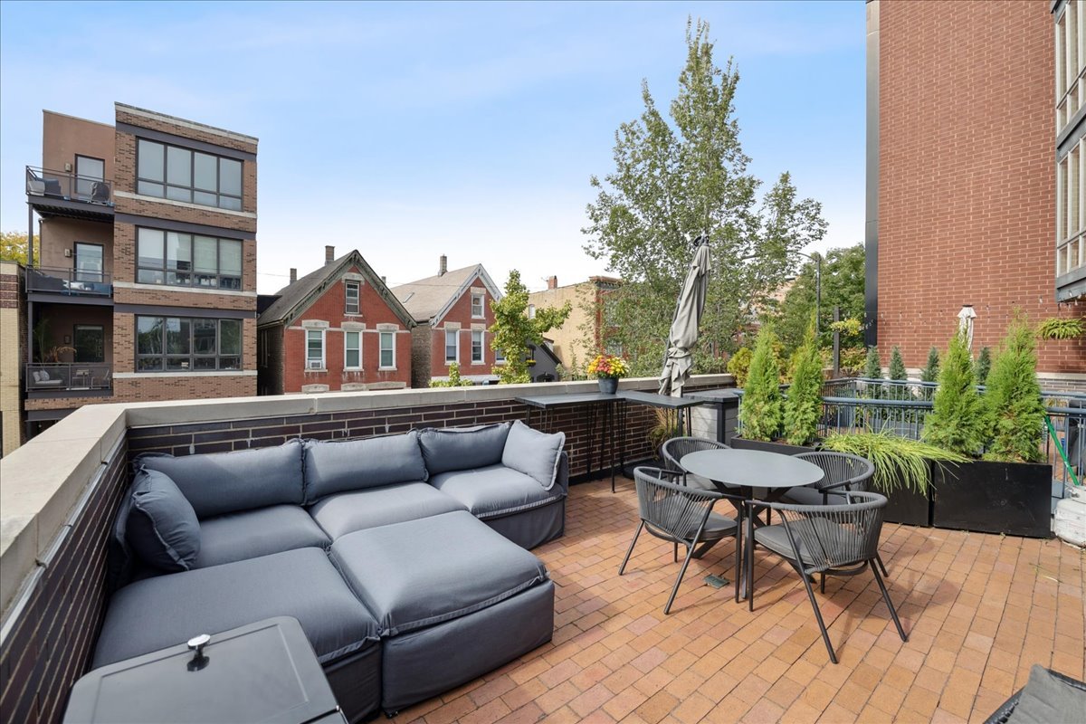 1915 North Damen Avenue, Unit A Chicago, IL 60647 - Photo 14 of 26 a view of a patio with couches and a potted plant on a table