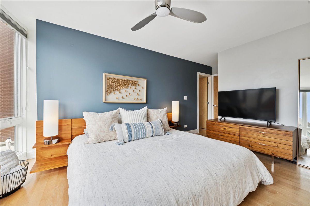 1915 North Damen Avenue, Unit A Chicago, IL 60647 - Photo 17 of 26 a bedroom with bed and a flat screen tv