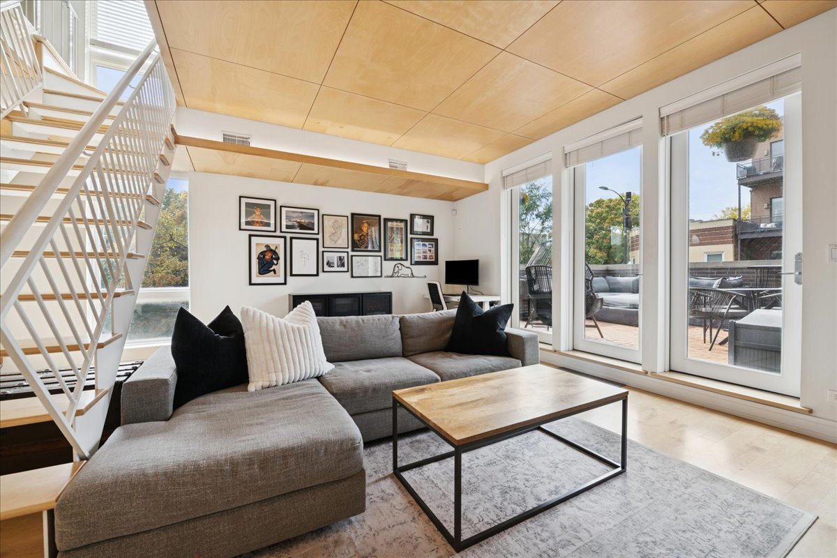 1915 North Damen Avenue, Unit A Chicago, IL 60647 - Photo 2 of 26 a living room with furniture and a large window