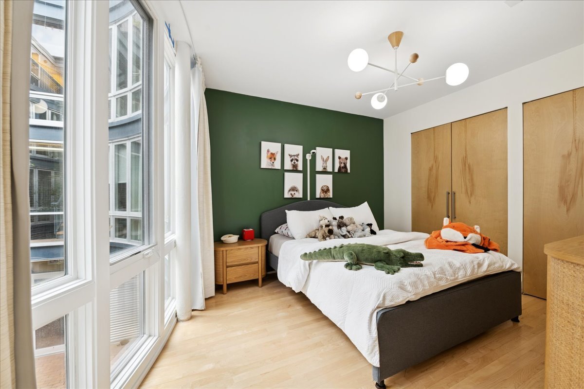 1915 North Damen Avenue, Unit A Chicago, IL 60647 - Photo 23 of 26 a bedroom with a bed and window