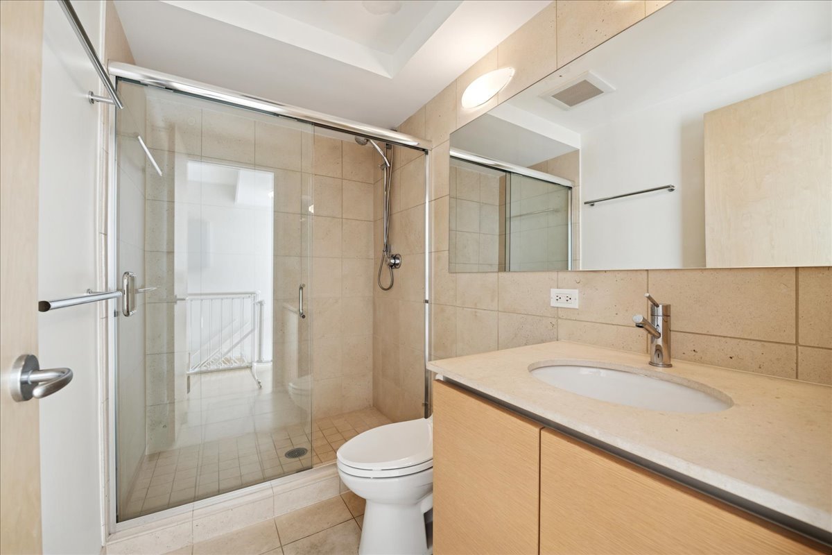 1915 North Damen Avenue, Unit A Chicago, IL 60647 - Photo 24 of 26 a bathroom with a sink toilet and shower