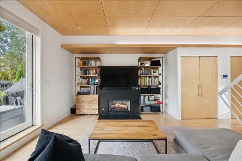 a living room with furniture a rug and a bookshelf