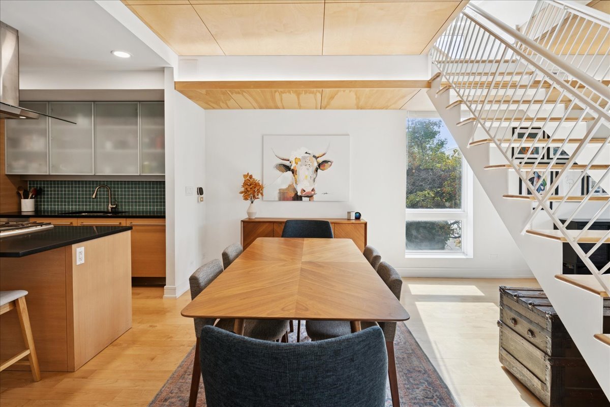 1915 North Damen Avenue, Unit A Chicago, IL 60647 - Photo 6 of 26 a living room with stainless steel appliances kitchen island a large window