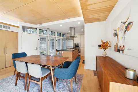 a dining room with furniture and wooden floor