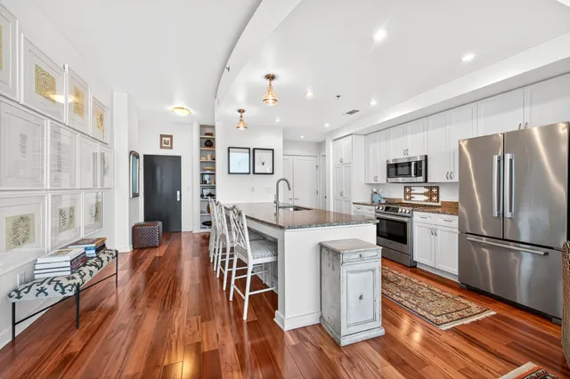 a kitchen with stainless steel appliances a refrigerator sink and cabinets