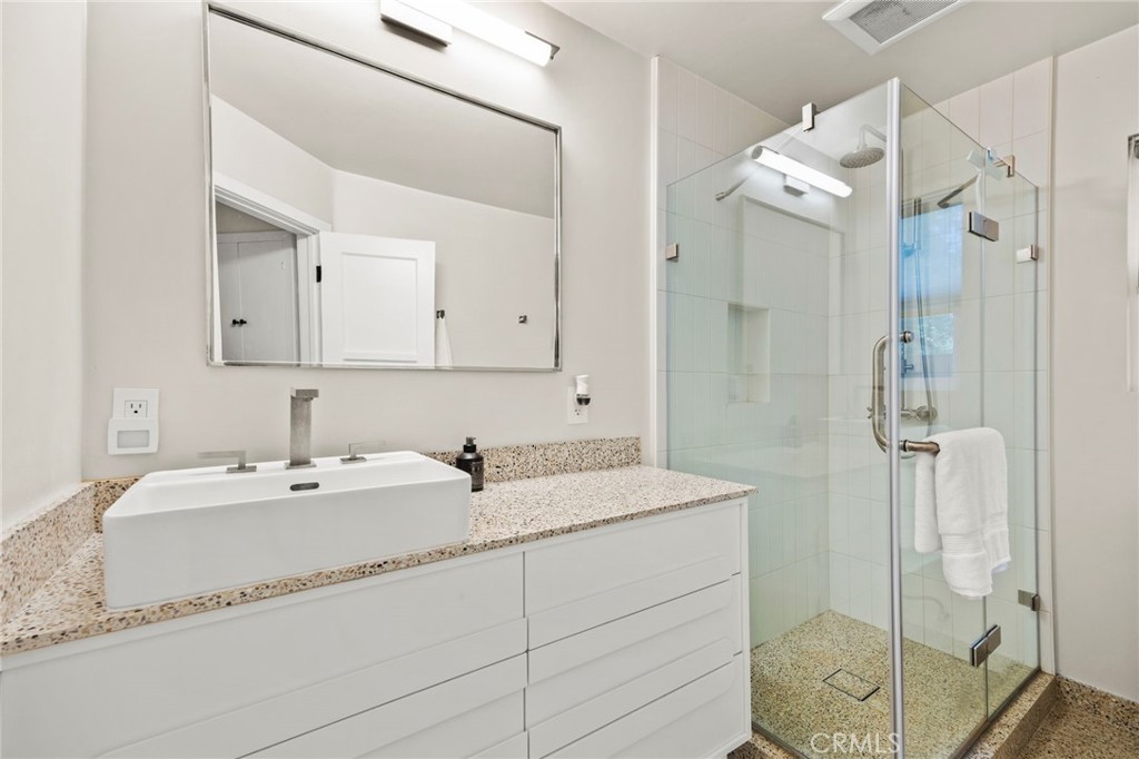 301 Park Road Ojai, CA 93023 - Photo 14 of 26 a bathroom with a double vanity sink mirror and shower