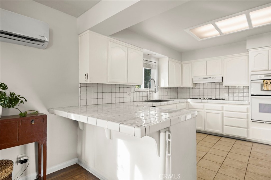 301 Park Road Ojai, CA 93023 - Photo 7 of 26 a kitchen with a sink stove and cabinets