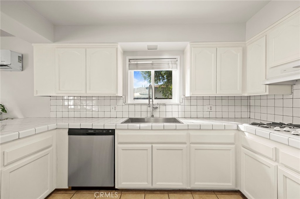 301 Park Road Ojai, CA 93023 - Photo 8 of 26 a kitchen with white cabinets appliances a sink and a window