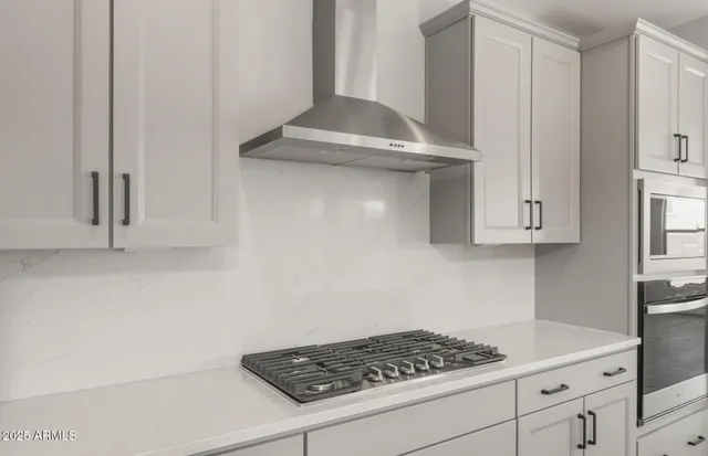 a kitchen with cabinets and appliances