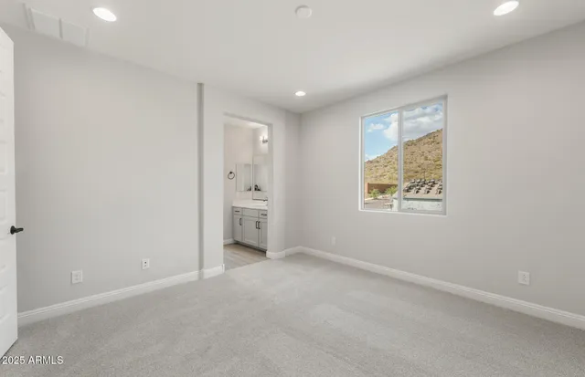 a bathroom with a sink a toilet and a large mirror