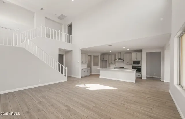 a view of large kitchen with wooden floor and windows