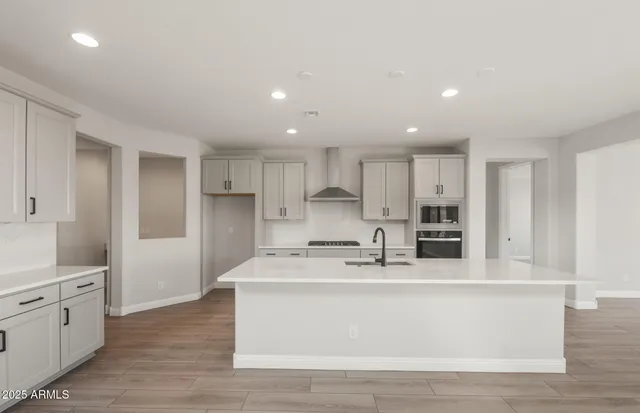 a view of large windows and a kitchen with wooden floor
