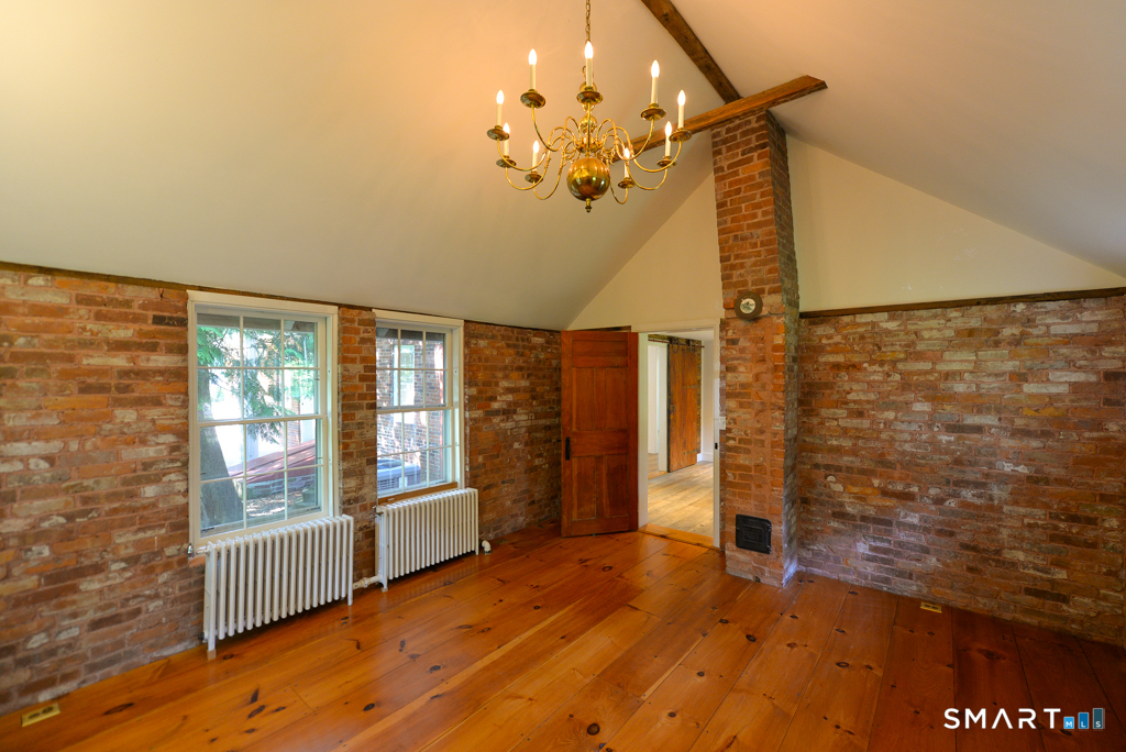 15 Hawkins Road Southbury, CT 06488 - Photo 13 of 26 an empty room with wooden floor and windows