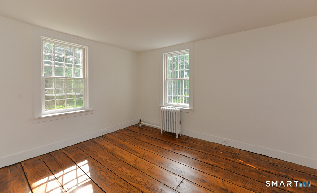 15 Hawkins Road Southbury, CT 06488 - Photo 15 of 26 an empty room with wooden floor and windows