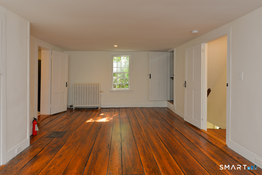 15 Hawkins Road Southbury, CT 06488 - Photo 18 of 26 a view of an empty room with wooden floor and a window