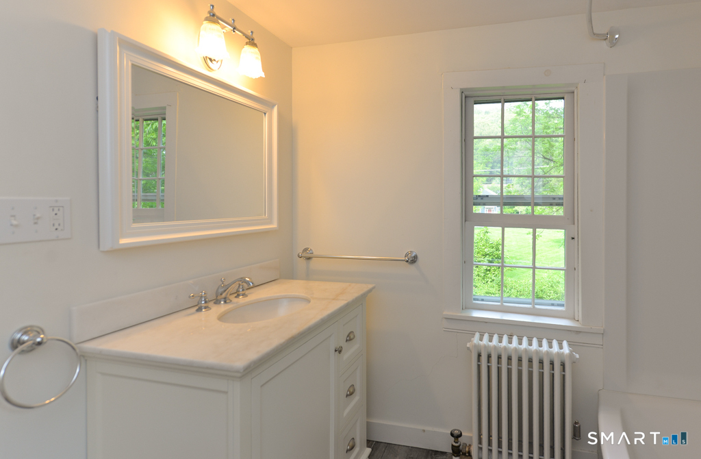 15 Hawkins Road Southbury, CT 06488 - Photo 20 of 26 a bathroom with a sink a mirror and a window