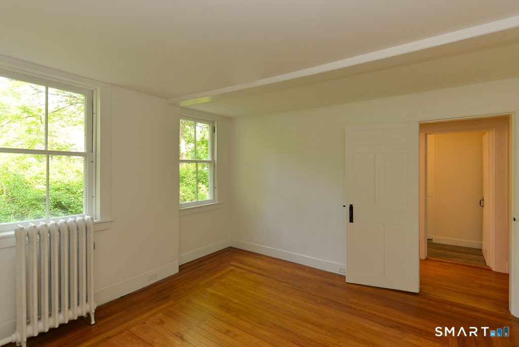 15 Hawkins Road Southbury, CT 06488 - Photo 6 of 26 a view of an empty room with wooden floor and a window