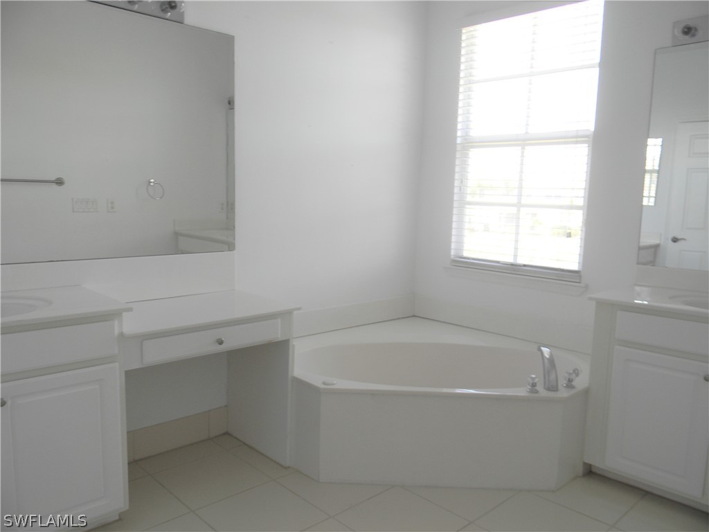 4109 Cherrybrook Loop Fort Myers, FL 33966 - Photo 13 of 32 a white bath tub sitting next to a window