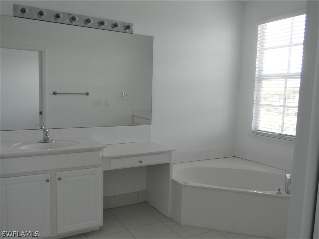 4109 Cherrybrook Loop Fort Myers, FL 33966 - Photo 15 of 32 a bathroom with a bathtub and a sink
