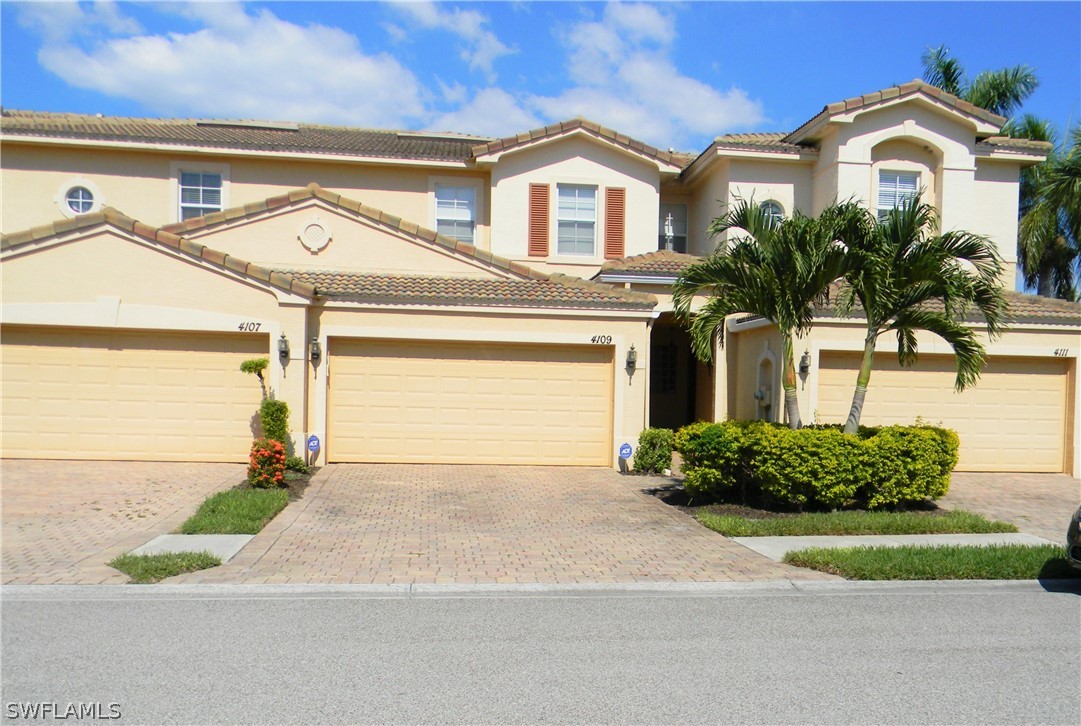 4109 Cherrybrook Loop Fort Myers, FL 33966 - Photo 32 of 32 a front view of a house with a yard and garage