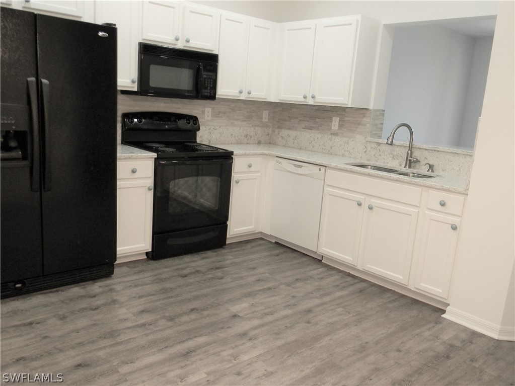 4109 Cherrybrook Loop Fort Myers, FL 33966 - Photo 7 of 32 a kitchen with a sink stove and refrigerator