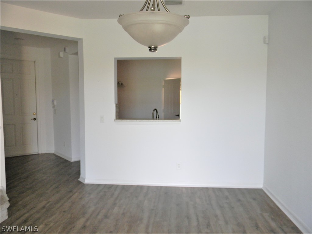 4109 Cherrybrook Loop Fort Myers, FL 33966 - Photo 9 of 32 a view of an empty room with wooden floor and a window