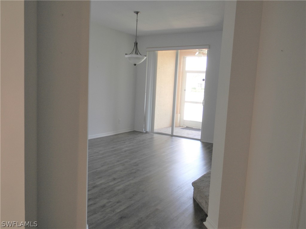 4109 Cherrybrook Loop Fort Myers, FL 33966 - Photo 10 of 32 an empty room with wooden floor and windows
