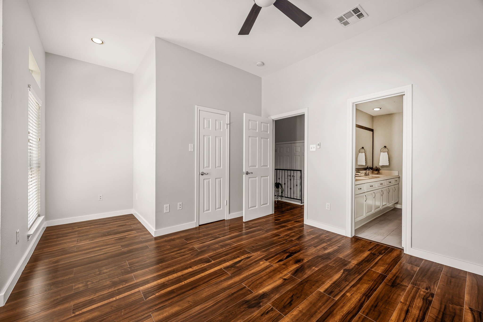 2918 Ranch Road 620 North, Unit S242 Austin, TX 78734 - Photo 27 of 35 Rich hardwood flooring stretches across this naturally illuminated bedroom with high ceilings and a ceiling fan.