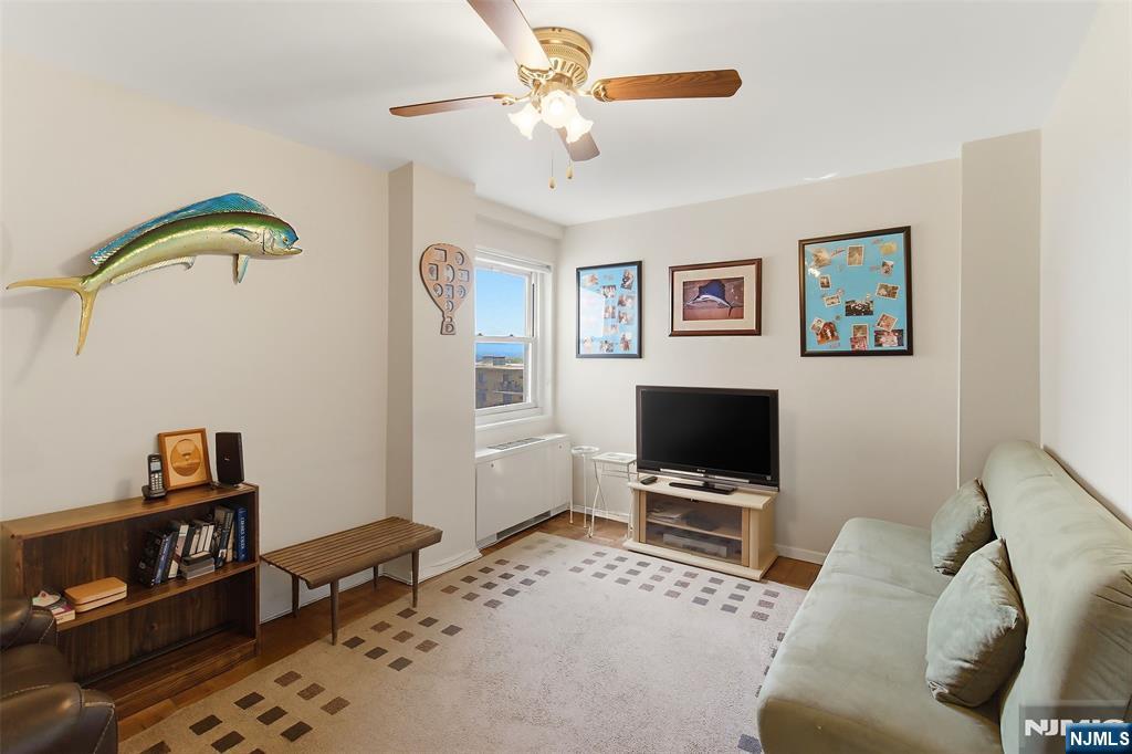 280 Prospect Avenue, Unit 8G Hackensack, NJ 07601 - Photo 15 of 23 a living room with furniture and a flat screen tv