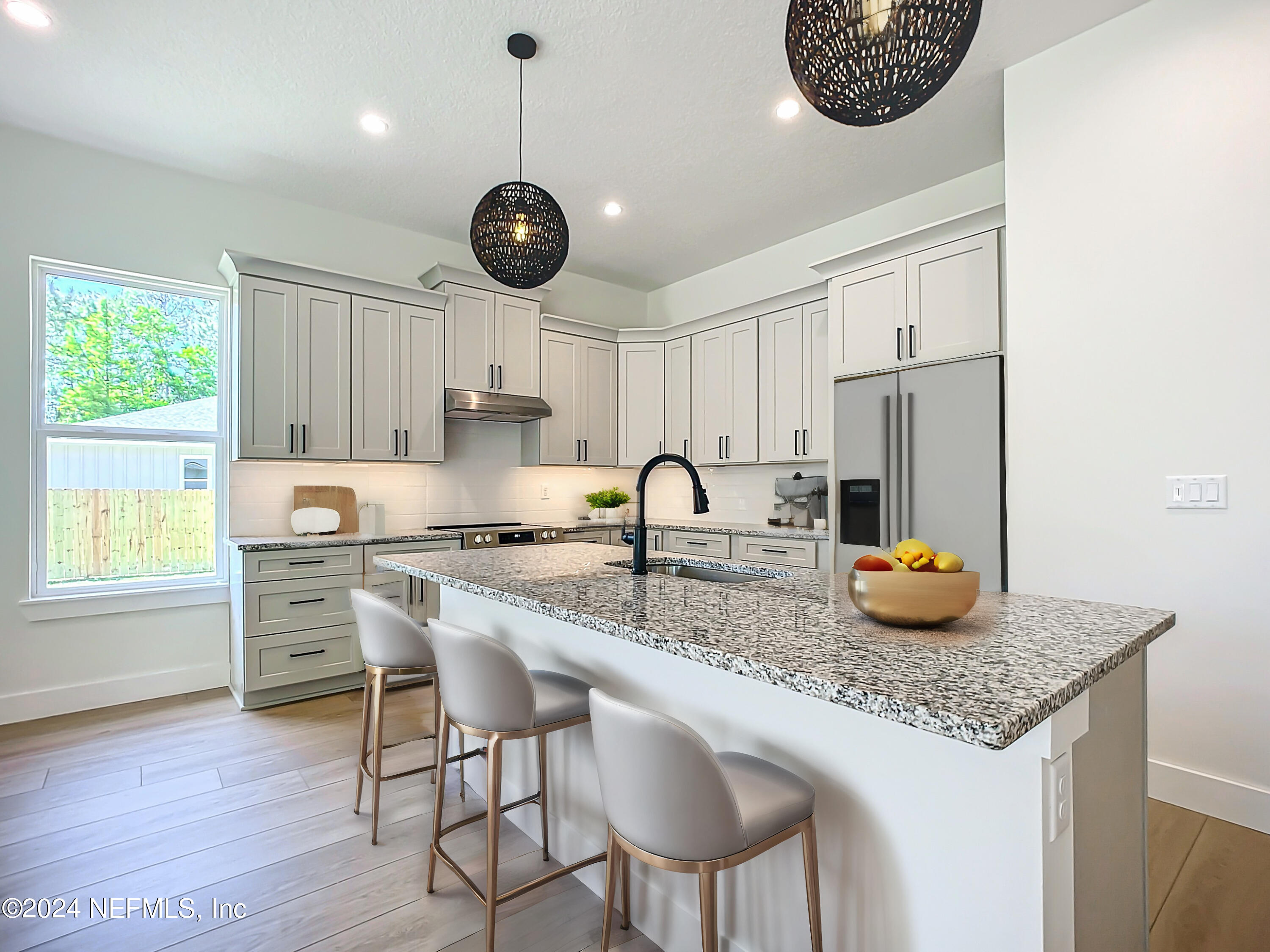 2903 Brougham Jacksonville, FL 32246 - Photo 11 of 40 a kitchen with stainless steel appliances granite countertop a stove a refrigerator a sink a dining table and chairs with wooden floor