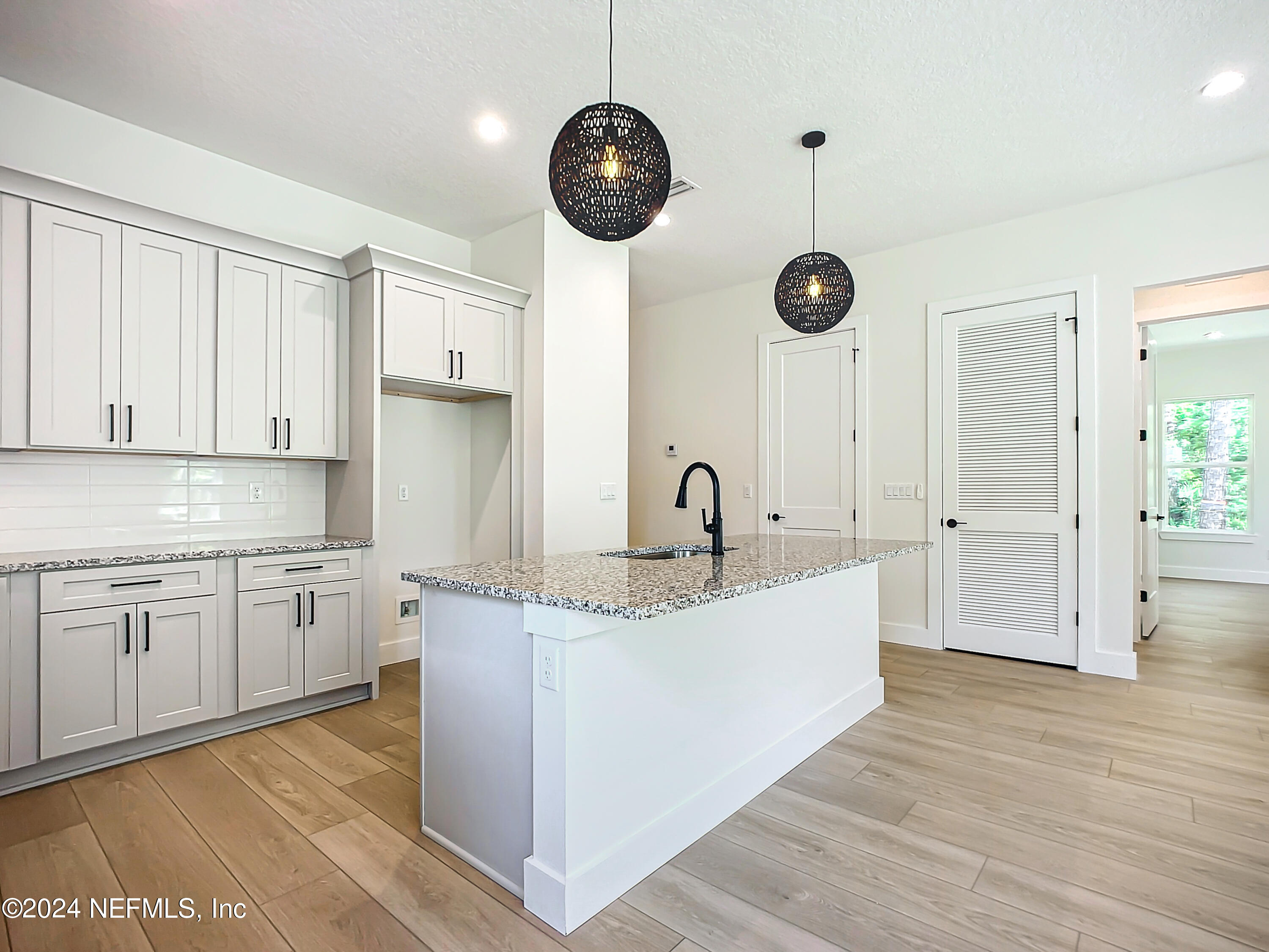 2903 Brougham Jacksonville, FL 32246 - Photo 14 of 40 a large kitchen with stainless steel appliances granite countertop a sink a oven and a wooden floors