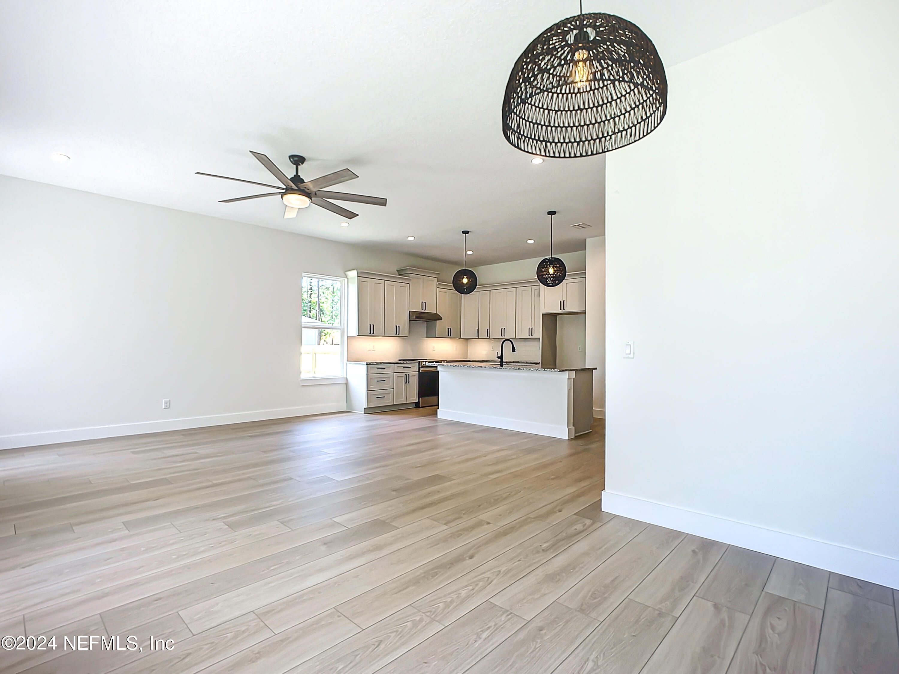 2903 Brougham Jacksonville, FL 32246 - Photo 16 of 40 a view of kitchen and empty room with wooden floor
