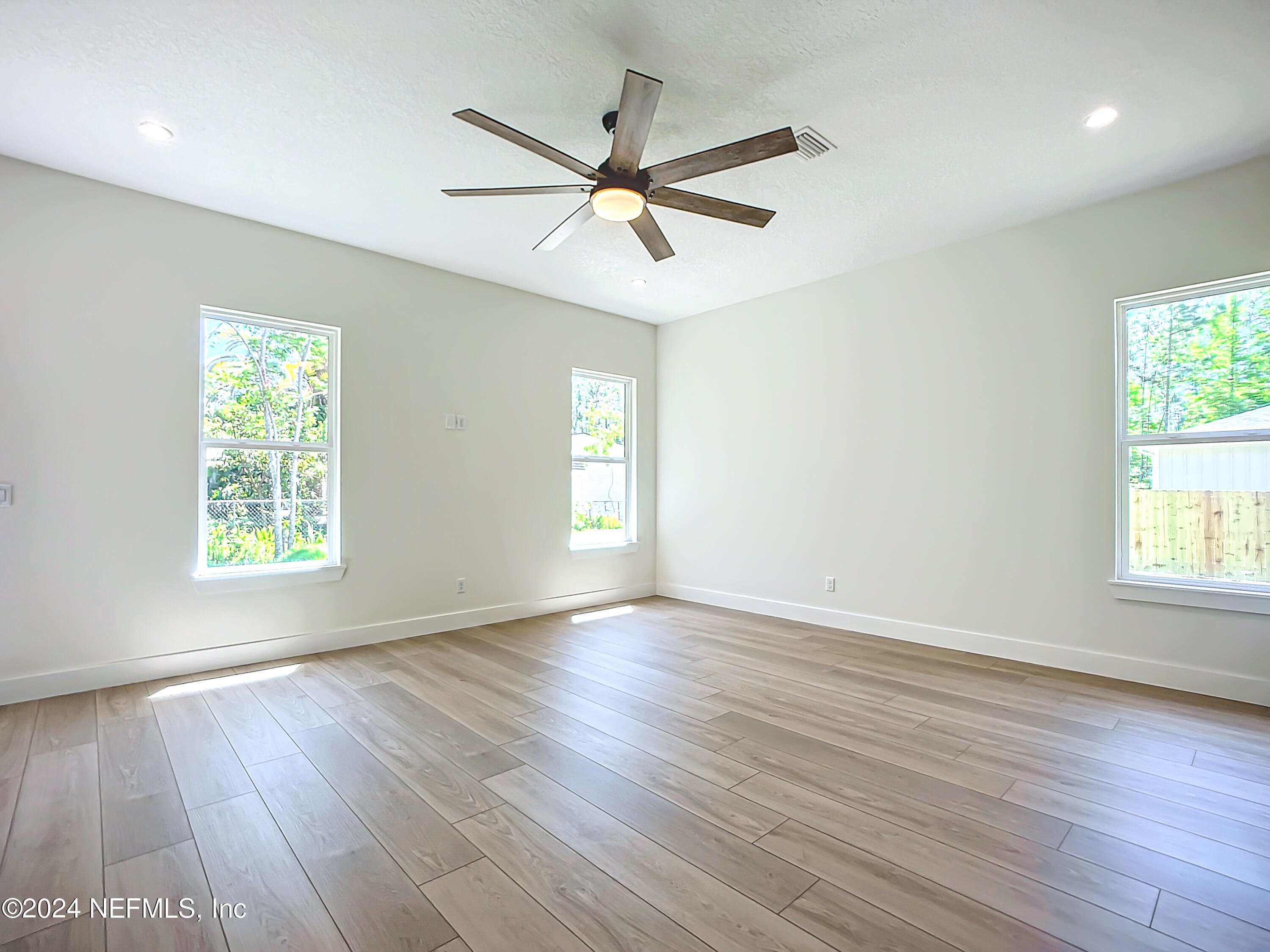 2903 Brougham Jacksonville, FL 32246 - Photo 18 of 40 wooden floor in an empty room with a window