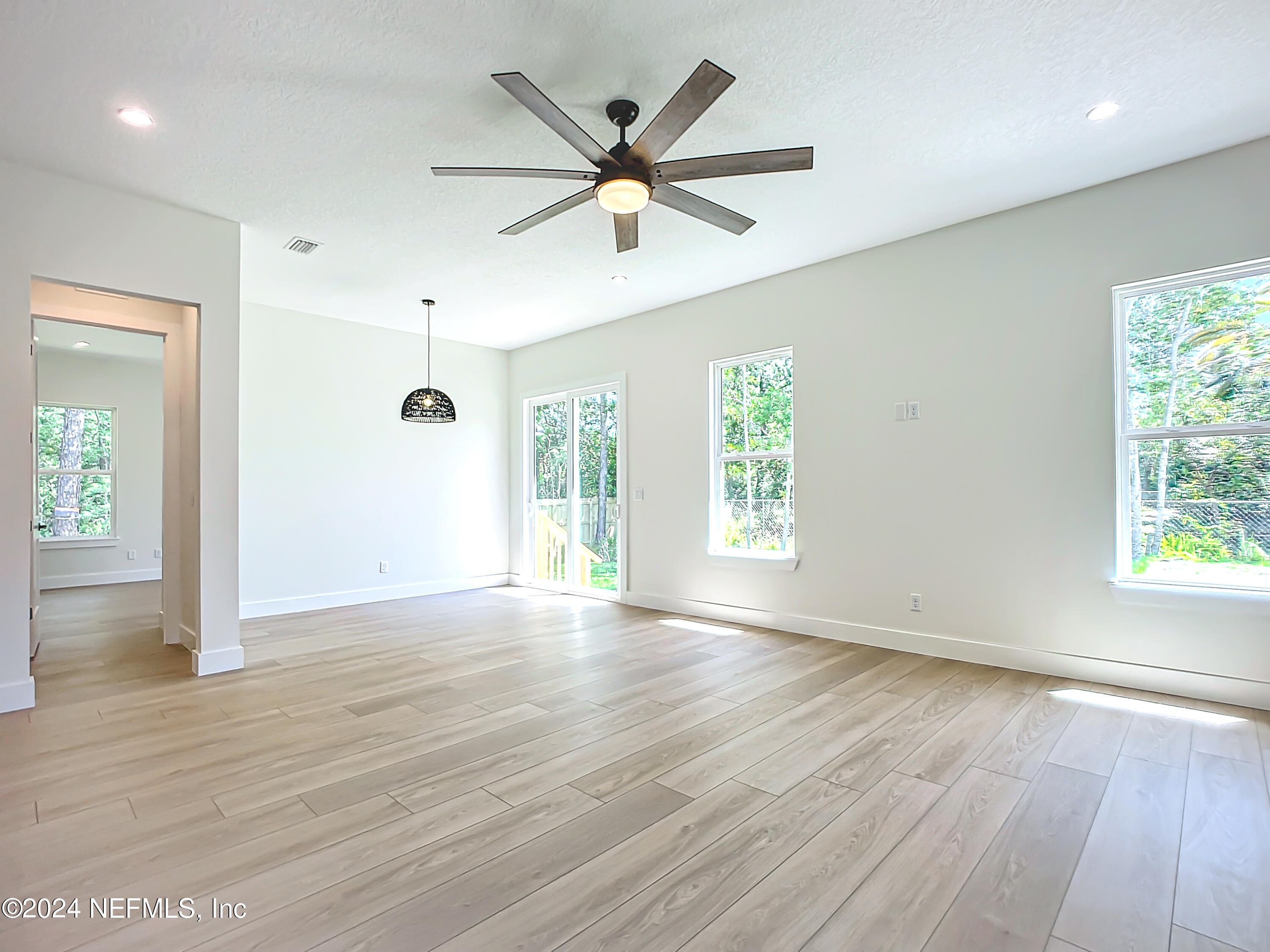 2903 Brougham Jacksonville, FL 32246 - Photo 19 of 40 a view of an empty room with wooden floor and a window