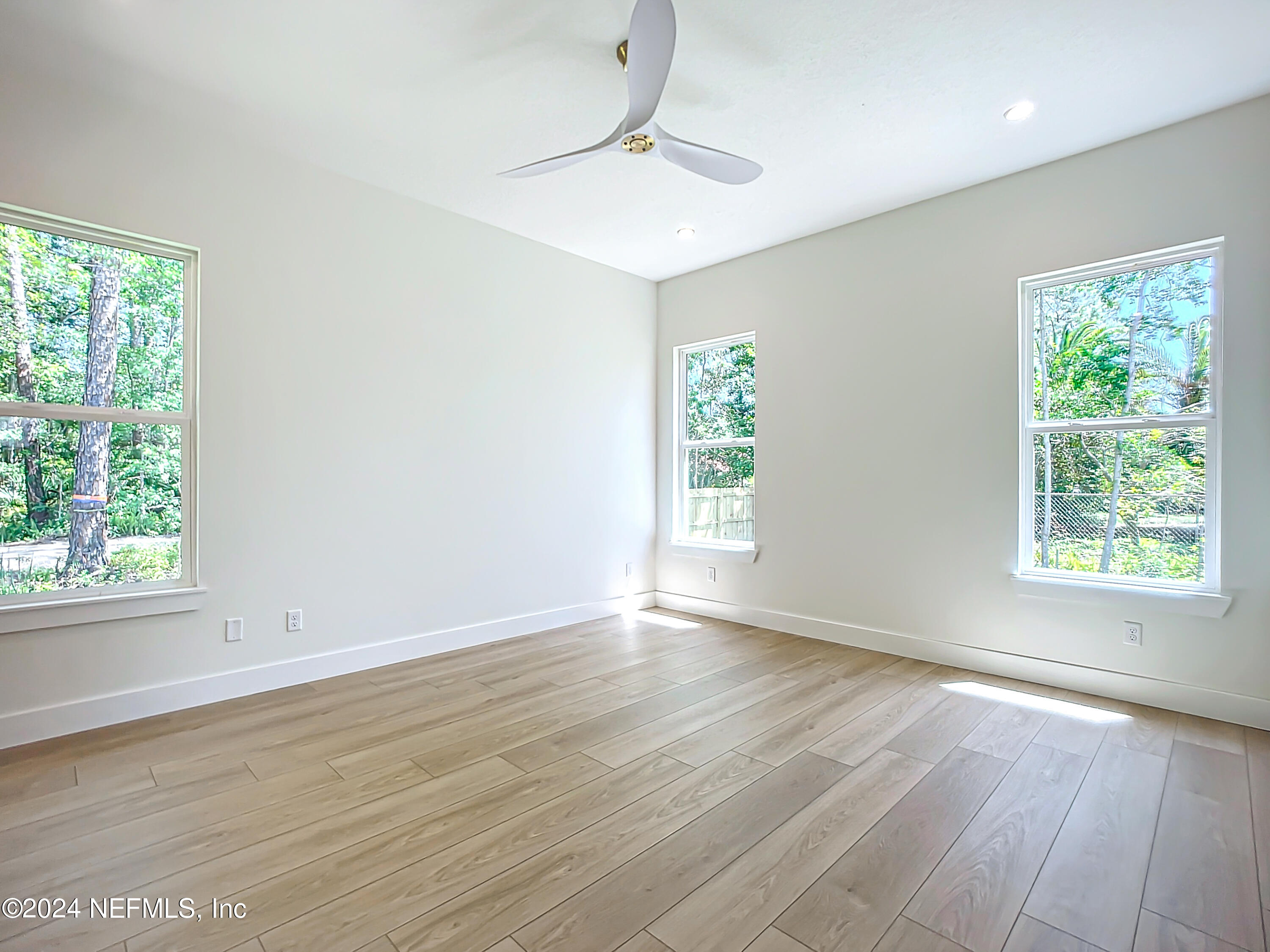 2903 Brougham Jacksonville, FL 32246 - Photo 20 of 40 a view of an empty room with wooden floor and a window
