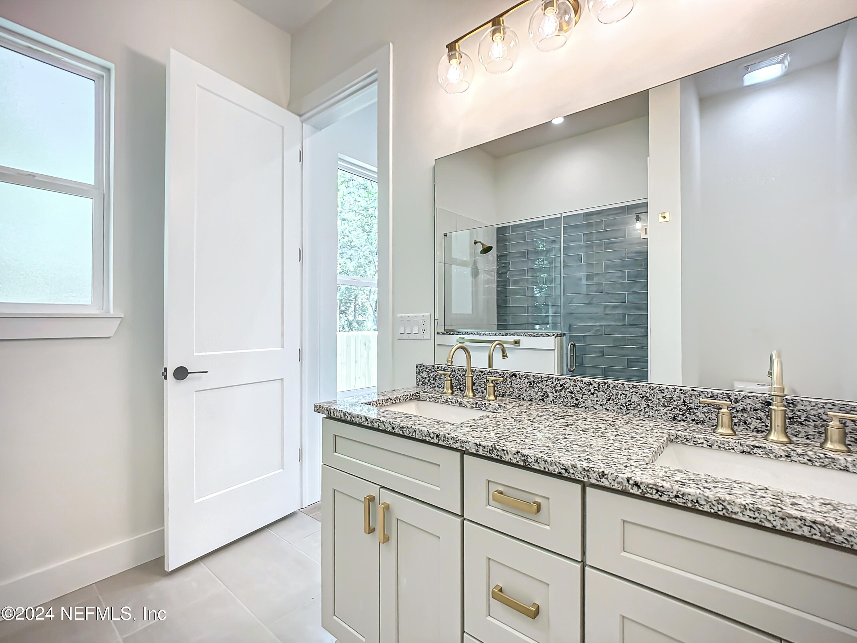 2903 Brougham Jacksonville, FL 32246 - Photo 22 of 40 a bathroom with a granite countertop sink and a mirror