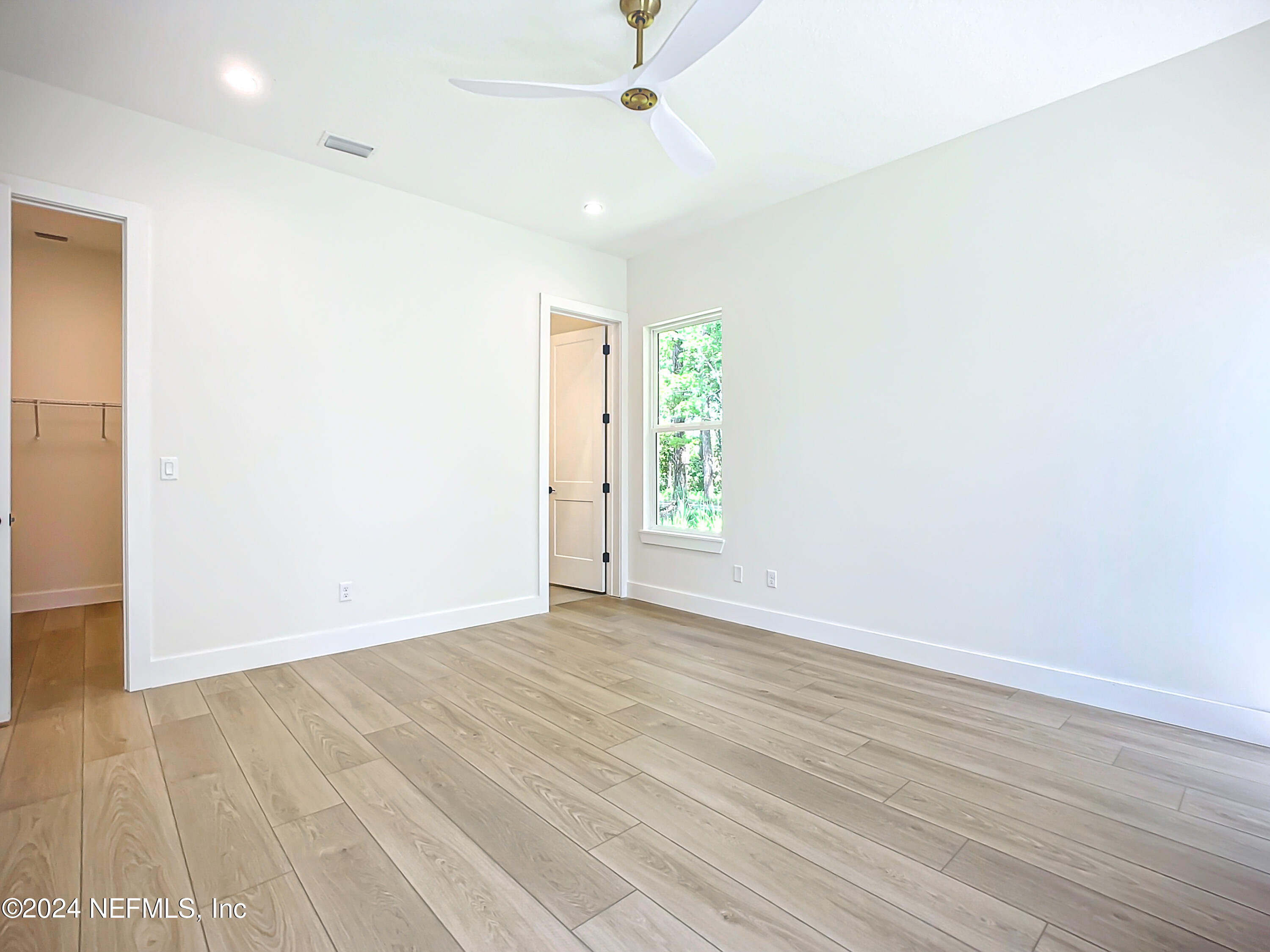 2903 Brougham Jacksonville, FL 32246 - Photo 25 of 40 an empty room with wooden floor fan and windows
