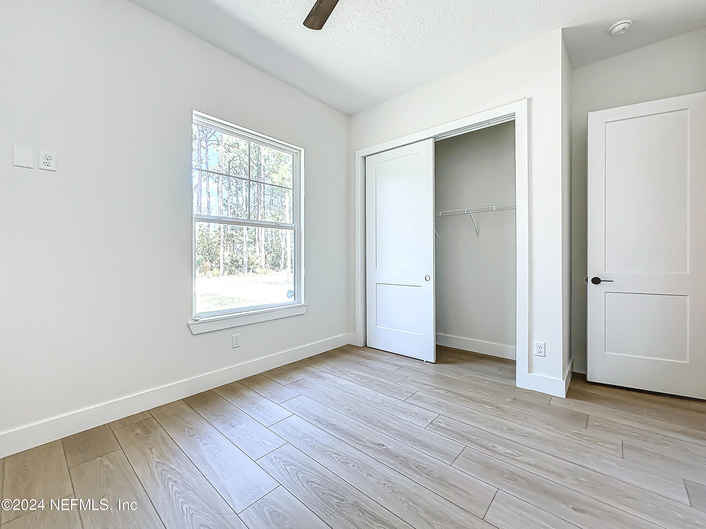 2903 Brougham Jacksonville, FL 32246 - Photo 26 of 40 an empty room with wooden floor and windows
