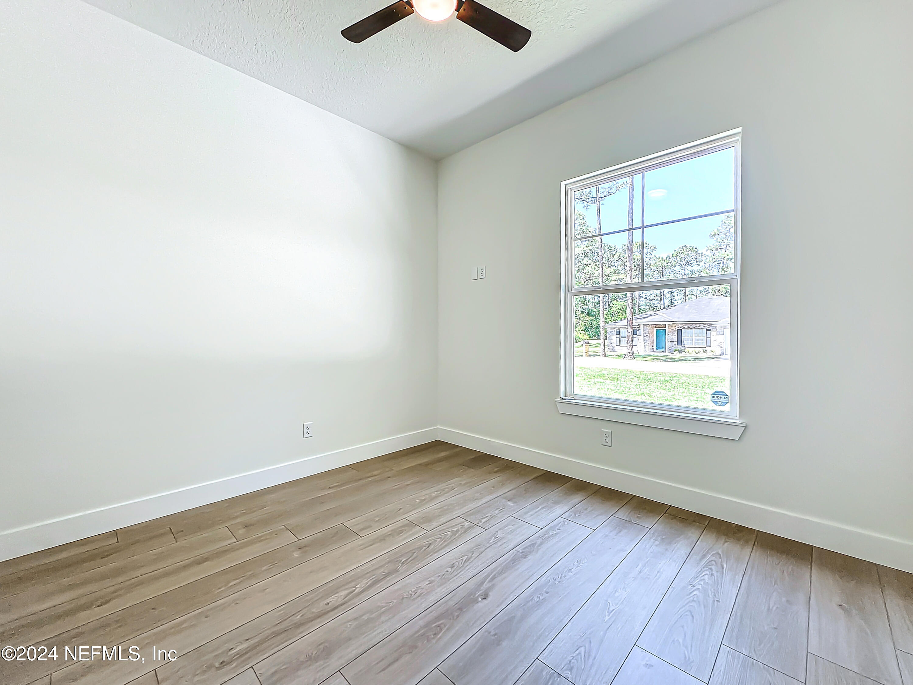 2903 Brougham Jacksonville, FL 32246 - Photo 27 of 40 an empty room with wooden floor and windows