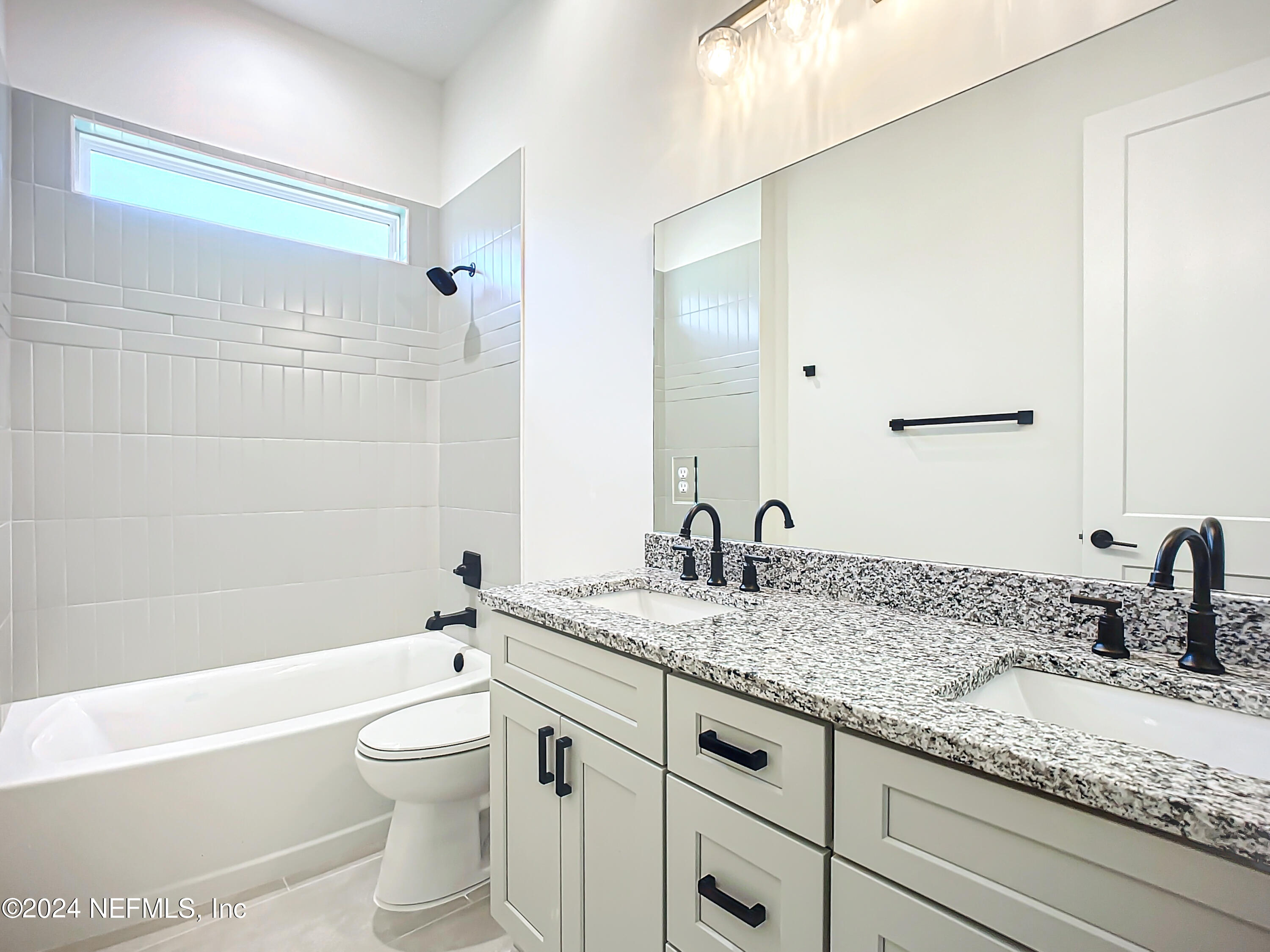 2903 Brougham Jacksonville, FL 32246 - Photo 28 of 40 a bathroom with a granite countertop sink a toilet and bathtub