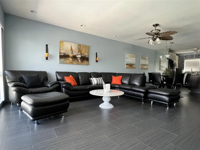 a living room with furniture a rug and a chandelier
