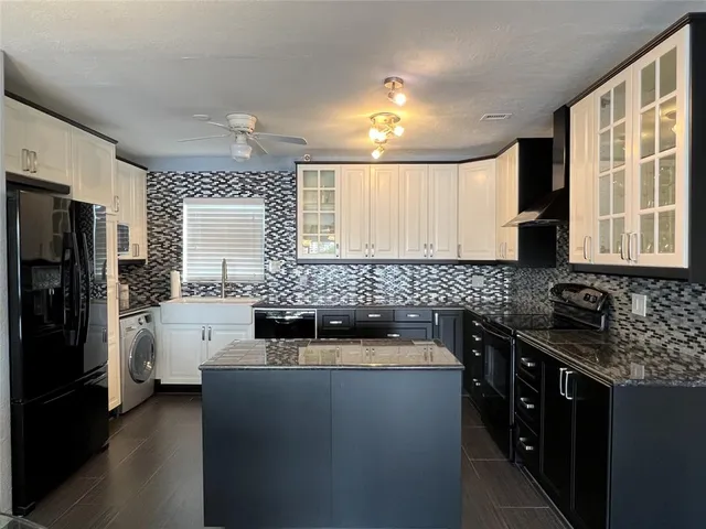 a kitchen with stainless steel appliances a sink stove and refrigerator