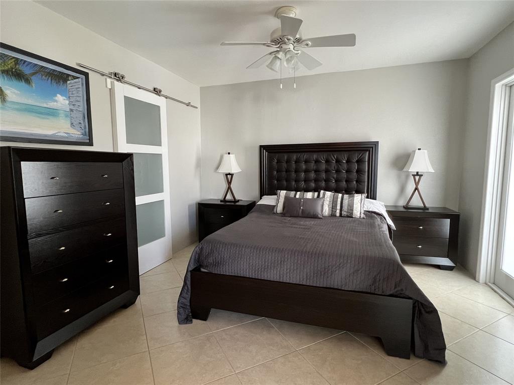 999 North Riverside Drive, Unit 9 Pompano Beach, FL 33062 - Photo 7 of 11 a bedroom with a bed and window