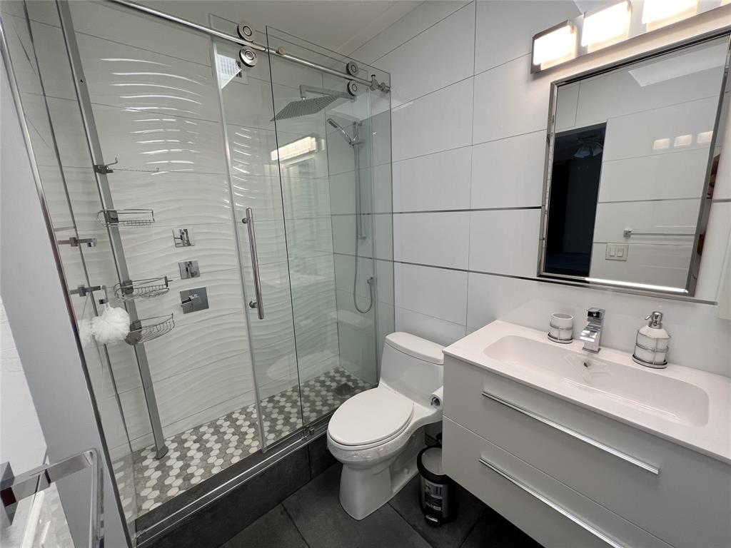 999 North Riverside Drive, Unit 9 Pompano Beach, FL 33062 - Photo 8 of 11 a bathroom with a sink a toilet and shower